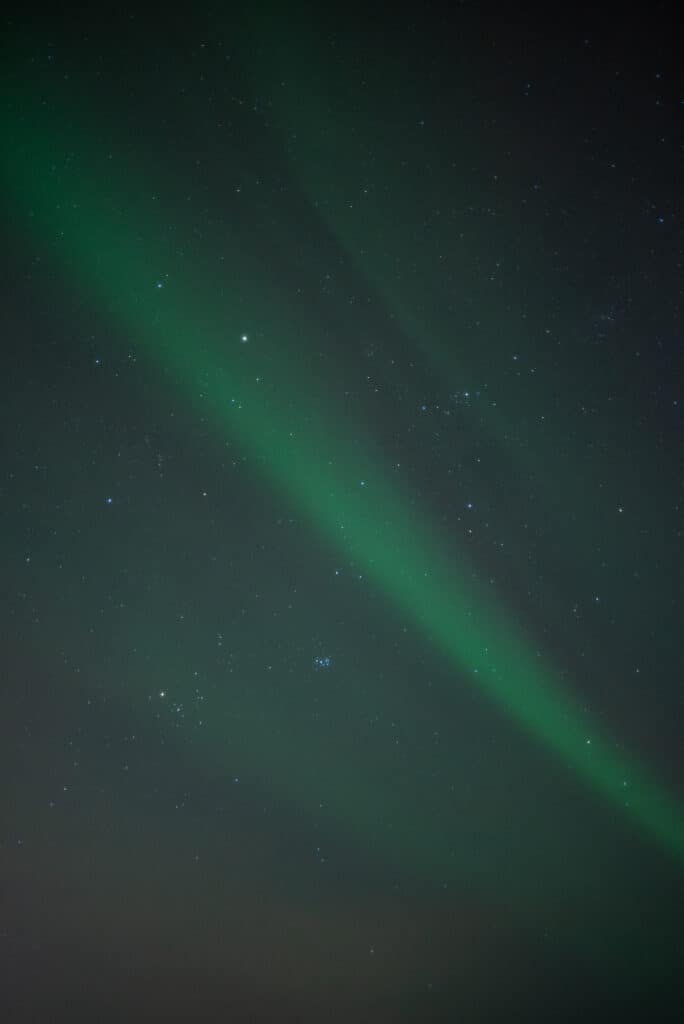 Greenish northern lights dancing in the sky of Tromso, Norway. 
